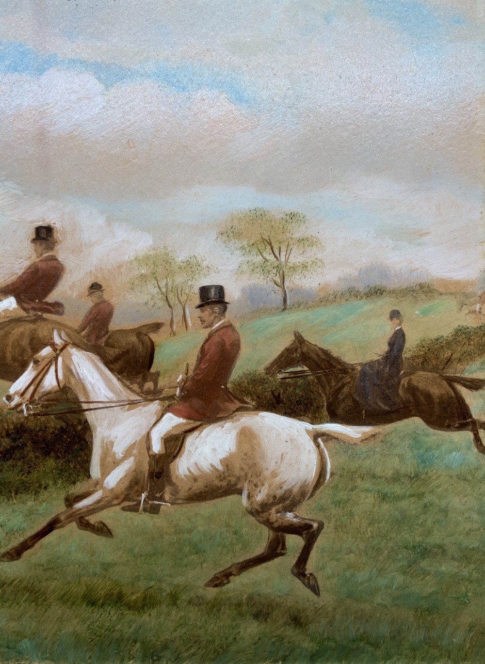 An oil painting on board depicting horseback riders navigating a grassy field, housed in a decorative gilded frame. View IV