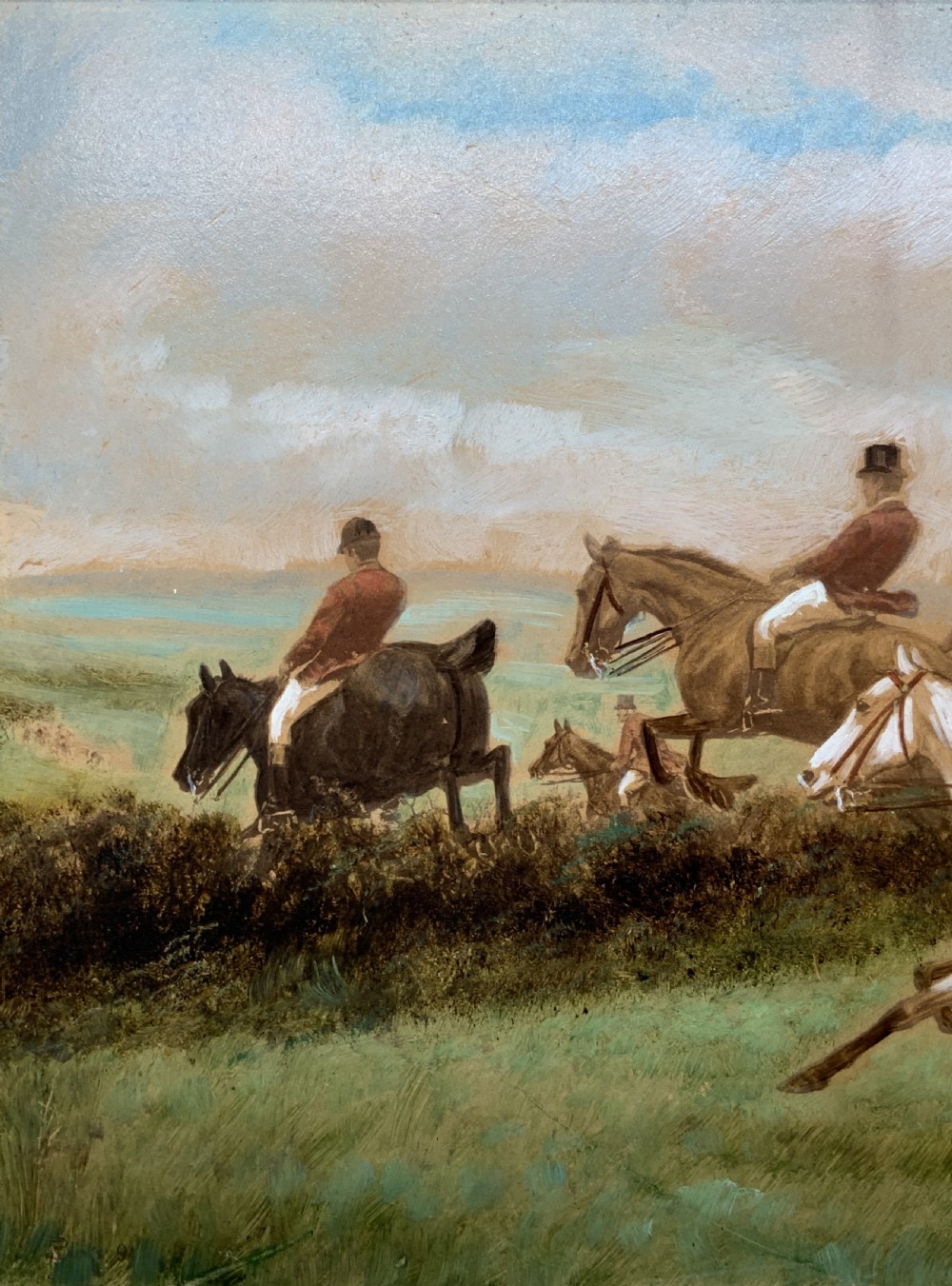 An oil painting on board depicting horseback riders navigating a grassy field, housed in a decorative gilded frame. View VI