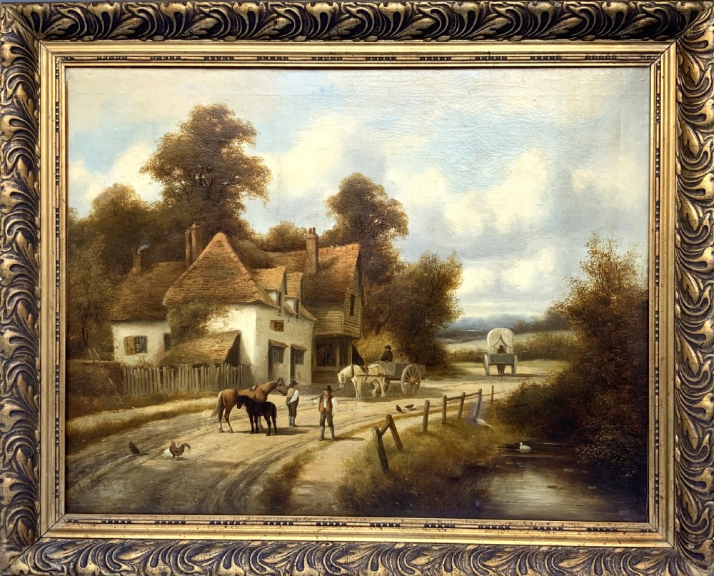 A 19th-century oil painting depicting a rural English village with horses, figures, and cottages on a dirt road, set in a carved gilded frame.