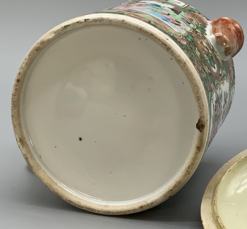 A 19th-century Chinese export porcelain barrel-form coffee pot with cover, decorated with famille rose enamel figural reserves and floral patterns. View XVIII