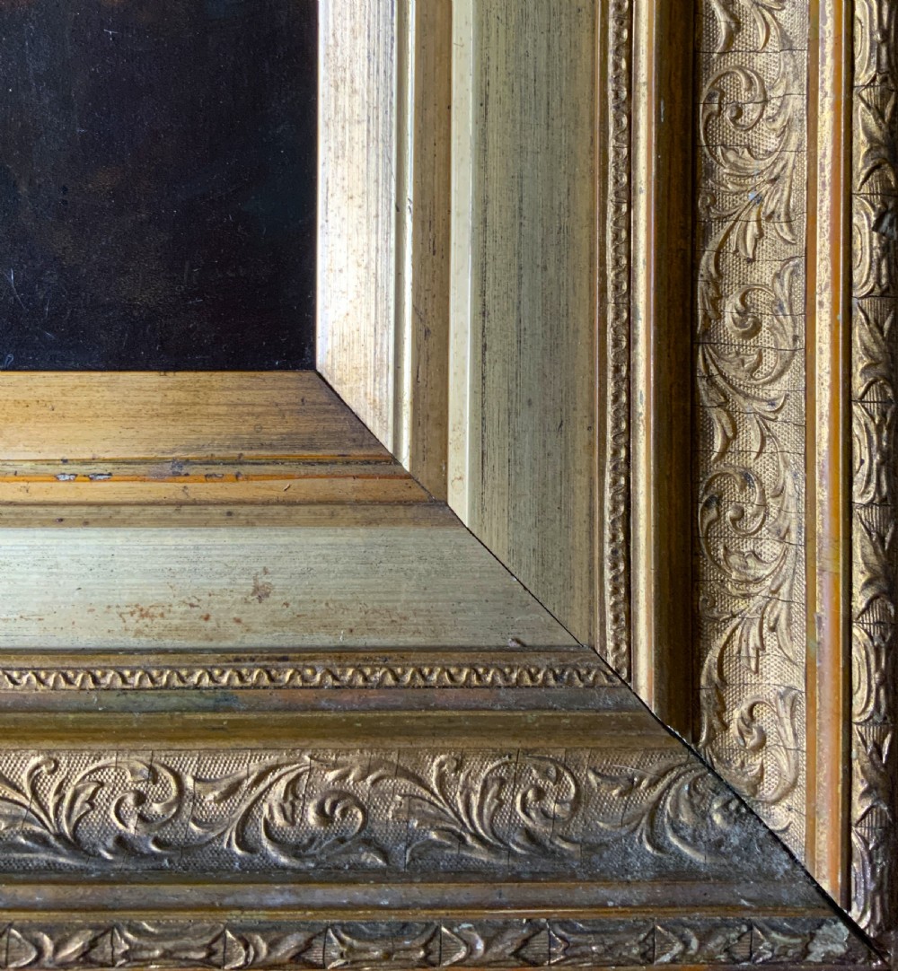 A 19th-century oil painting depicting a seated gentleman in a brown coat and waistcoat holding a small book, encased in an ornate gilded frame. View XI