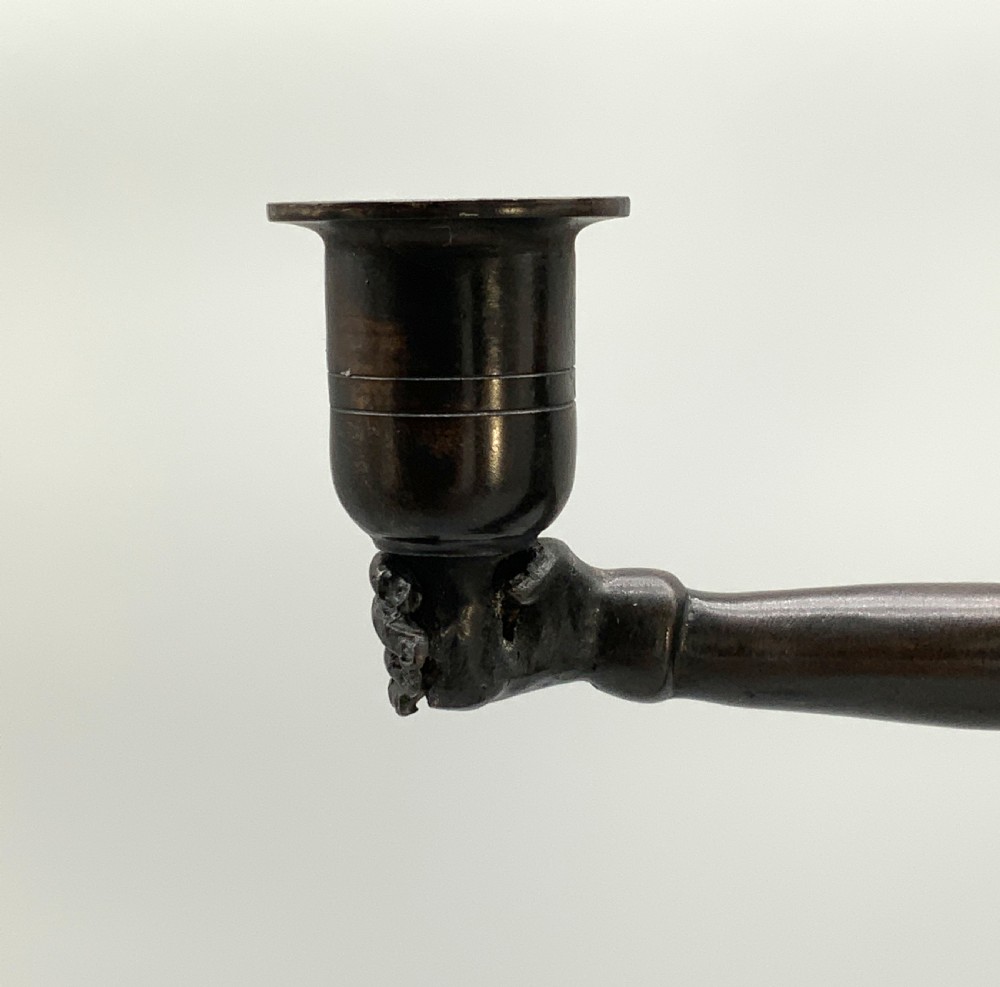 A patinated bronze Egyptian Revival candelabra featuring a female figure with outstretched arms holding two candle sockets, standing on a decorated triangular base. View XV