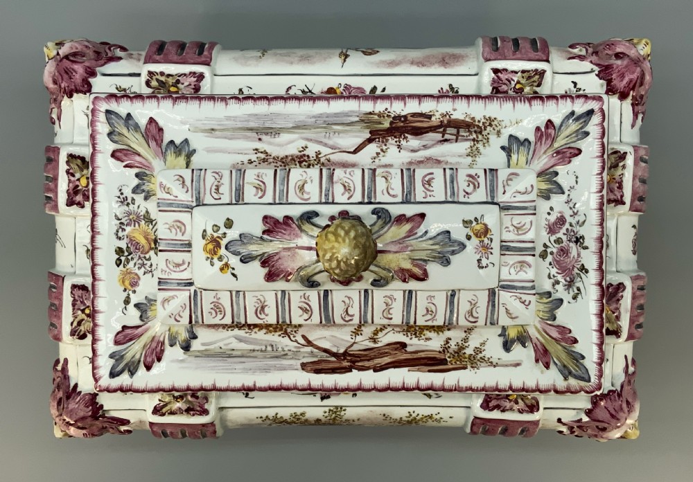 An antique French faience covered soup tureen featuring hand-painted pastoral scenes in manganese purple, moulded lion mask side handles, and a stepped lid with a finial. View VIII