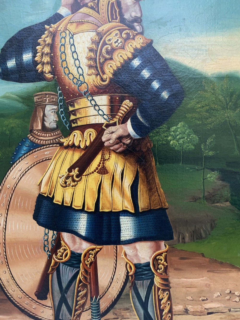 An antique framed oil painting depicting Goliath clad in ornate gold and blue armour holding a spear, with David standing across a stream in the background. View IX