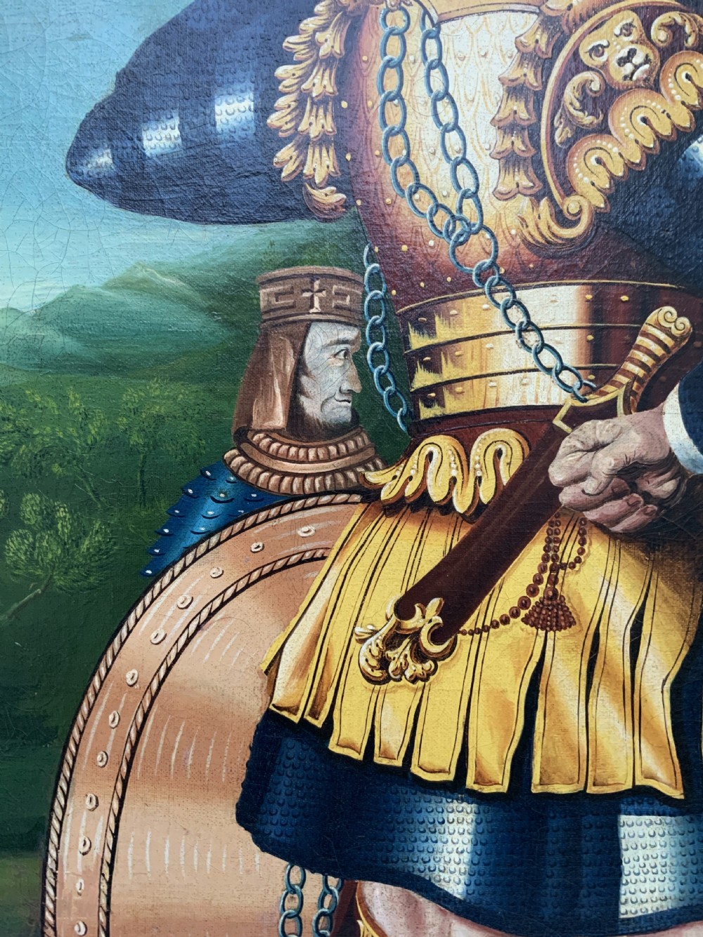 An antique framed oil painting depicting Goliath clad in ornate gold and blue armour holding a spear, with David standing across a stream in the background. View XIII