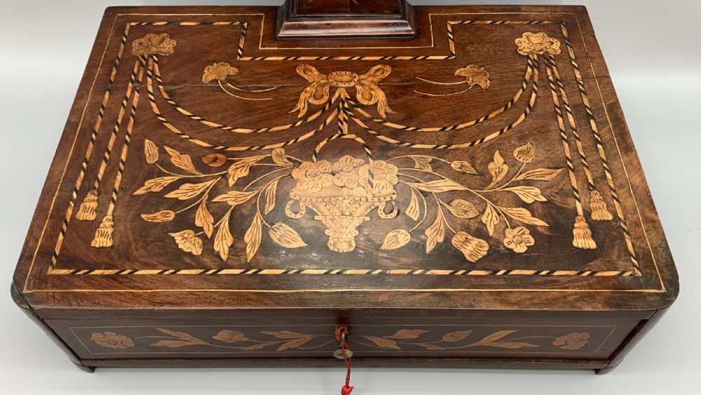 A 19th-century Dutch marquetry toilet mirror featuring a circular swivelling glass frame supported by carved wooden arms above a single base drawer decorated with detailed floral timber inlays. View V