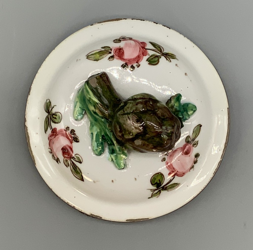 An 18th-century Italian tin-glazed earthenware pharmacy wet drug jug with a spouted body, top handle, lid with sculpted finial, painted armorial crest, floral scrolls, and Latin text reading Syr Alth. View X