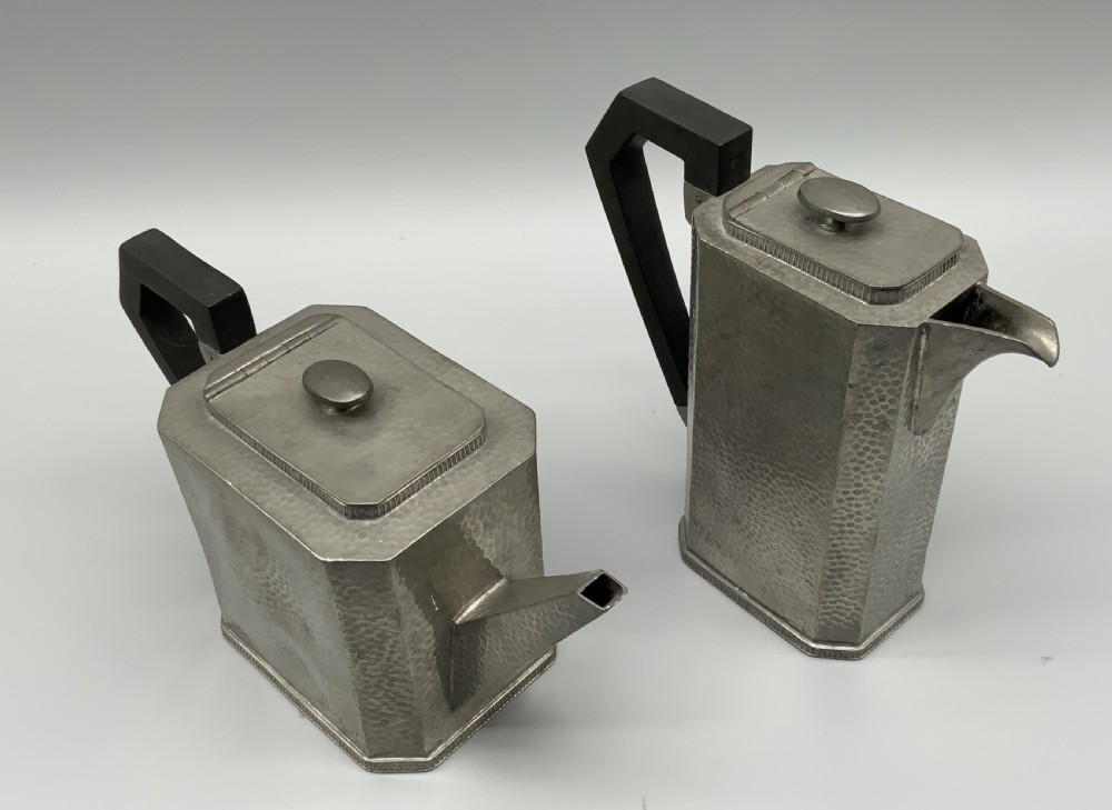 A five-piece Art Deco pewter tea and coffee set featuring a planished finish, geometric handles, and an octagonal tray. View VIII