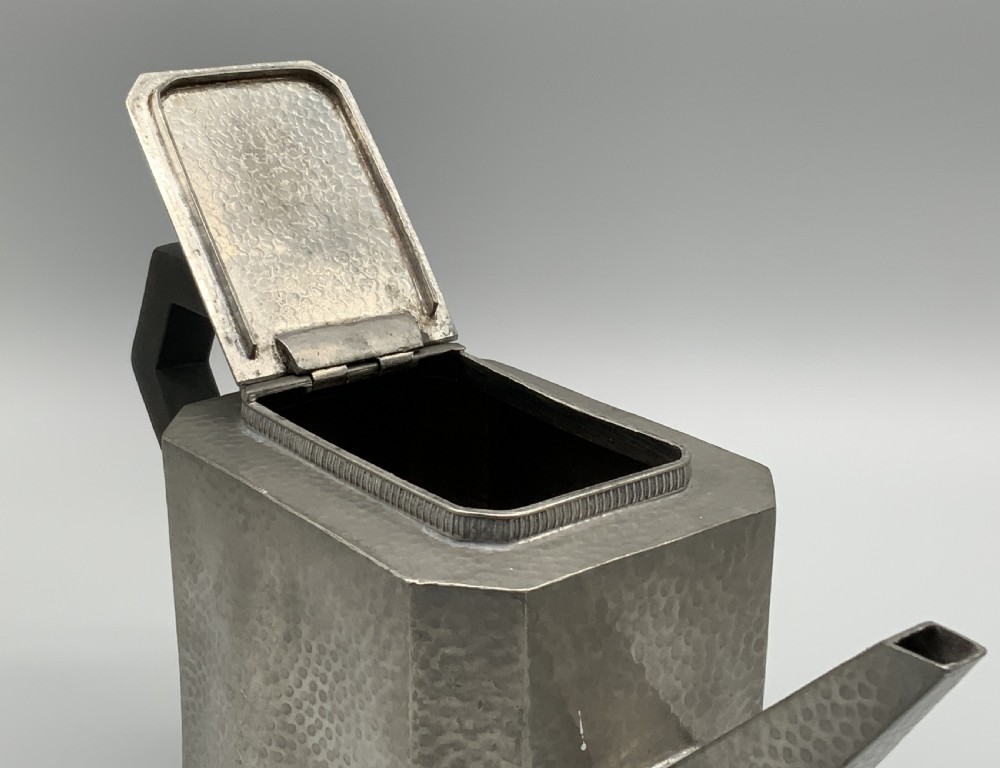 A five-piece Art Deco pewter tea and coffee set featuring a planished finish, geometric handles, and an octagonal tray. View XI