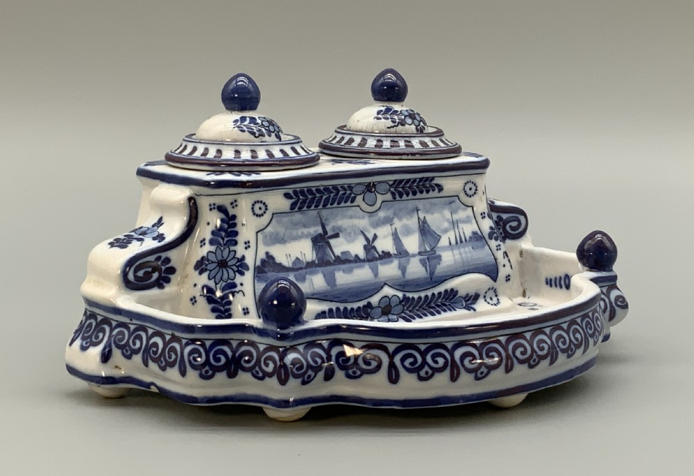 A late nineteenth-century Dutch Delft blue and white ceramic inkstand featuring twin removable lids, an integrated pen tray, and hand-painted windmill landscape scenes. View III