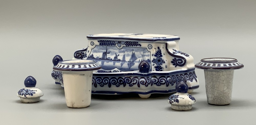 A late nineteenth-century Dutch Delft blue and white ceramic inkstand featuring twin removable lids, an integrated pen tray, and hand-painted windmill landscape scenes. View VI