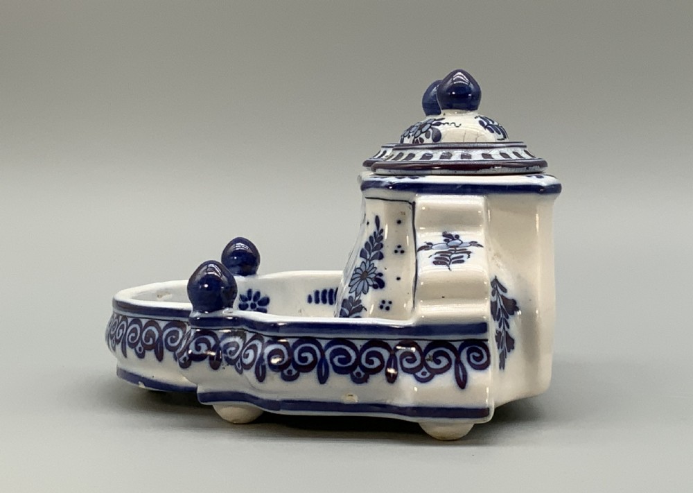 A late nineteenth-century Dutch Delft blue and white ceramic inkstand featuring twin removable lids, an integrated pen tray, and hand-painted windmill landscape scenes. View VII