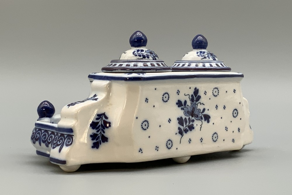 A late nineteenth-century Dutch Delft blue and white ceramic inkstand featuring twin removable lids, an integrated pen tray, and hand-painted windmill landscape scenes. View VIII