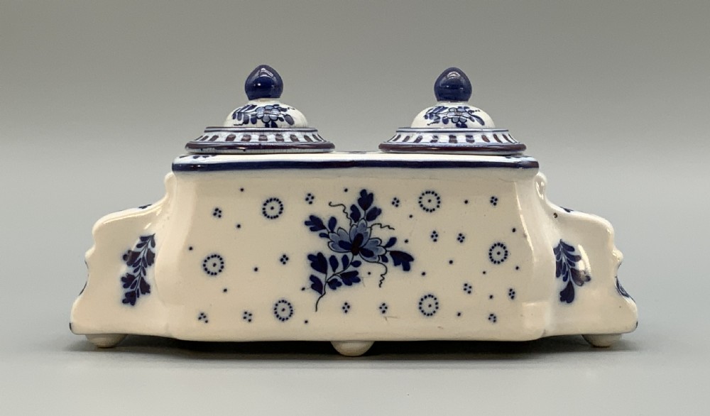 A late nineteenth-century Dutch Delft blue and white ceramic inkstand featuring twin removable lids, an integrated pen tray, and hand-painted windmill landscape scenes. View IX
