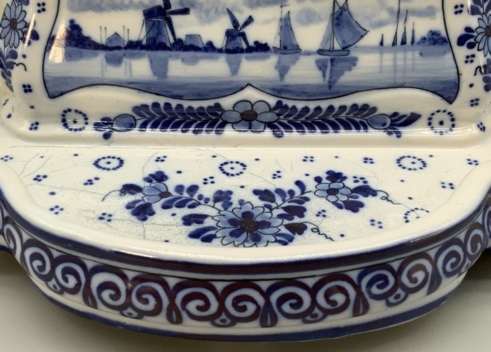 A late nineteenth-century Dutch Delft blue and white ceramic inkstand featuring twin removable lids, an integrated pen tray, and hand-painted windmill landscape scenes. View XIV