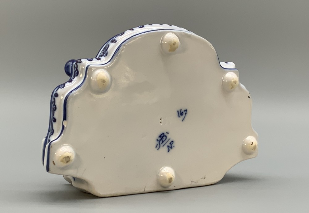 A late nineteenth-century Dutch Delft blue and white ceramic inkstand featuring twin removable lids, an integrated pen tray, and hand-painted windmill landscape scenes. View XV