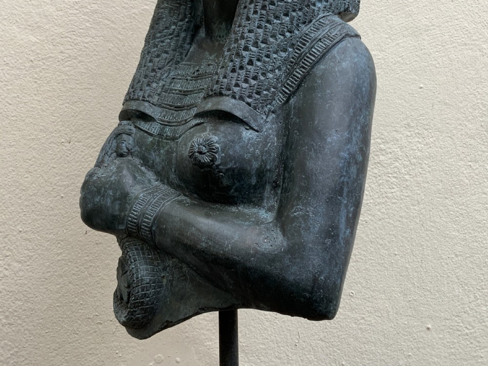 A dark green patinated bronze bust of Cleopatra holding an asp, mounted on a rectangular pink marble base. View XIII