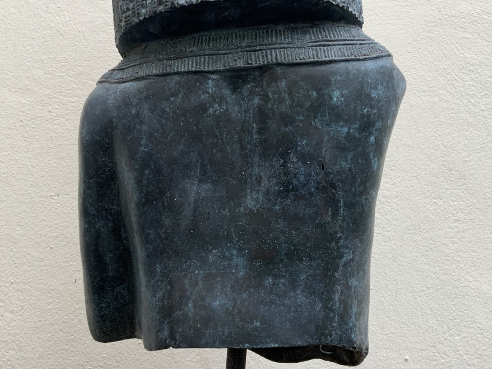 A dark green patinated bronze bust of Cleopatra holding an asp, mounted on a rectangular pink marble base. View XVI