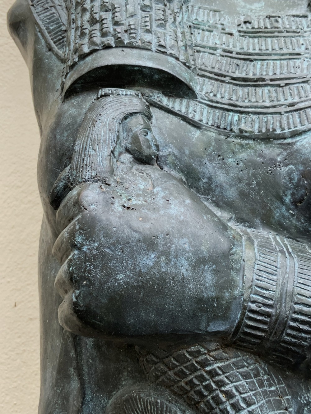 A dark green patinated bronze bust of Cleopatra holding an asp, mounted on a rectangular pink marble base. View XVIII