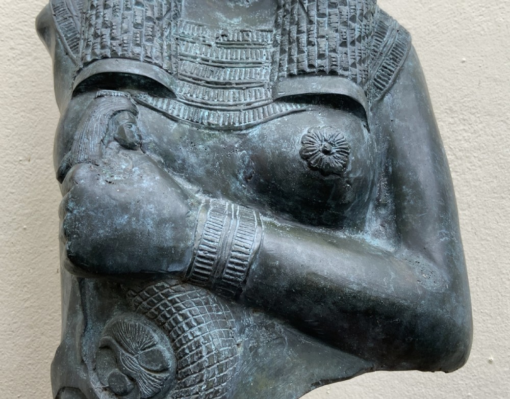 A dark green patinated bronze bust of Cleopatra holding an asp, mounted on a rectangular pink marble base. View XIX