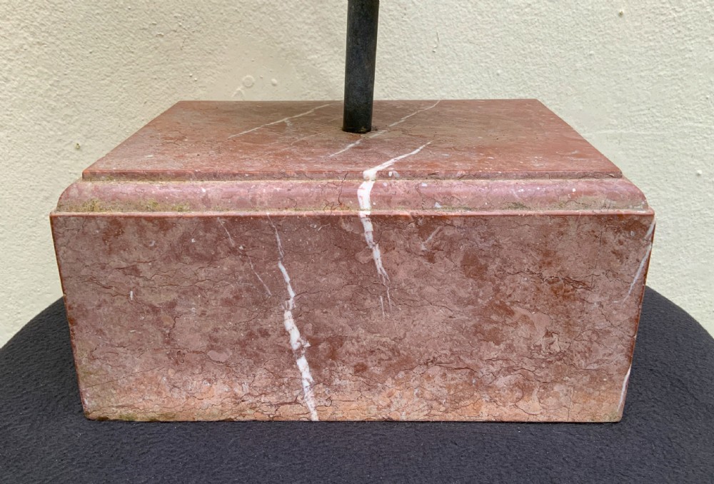 A dark green patinated bronze bust of Cleopatra holding an asp, mounted on a rectangular pink marble base. View XXI