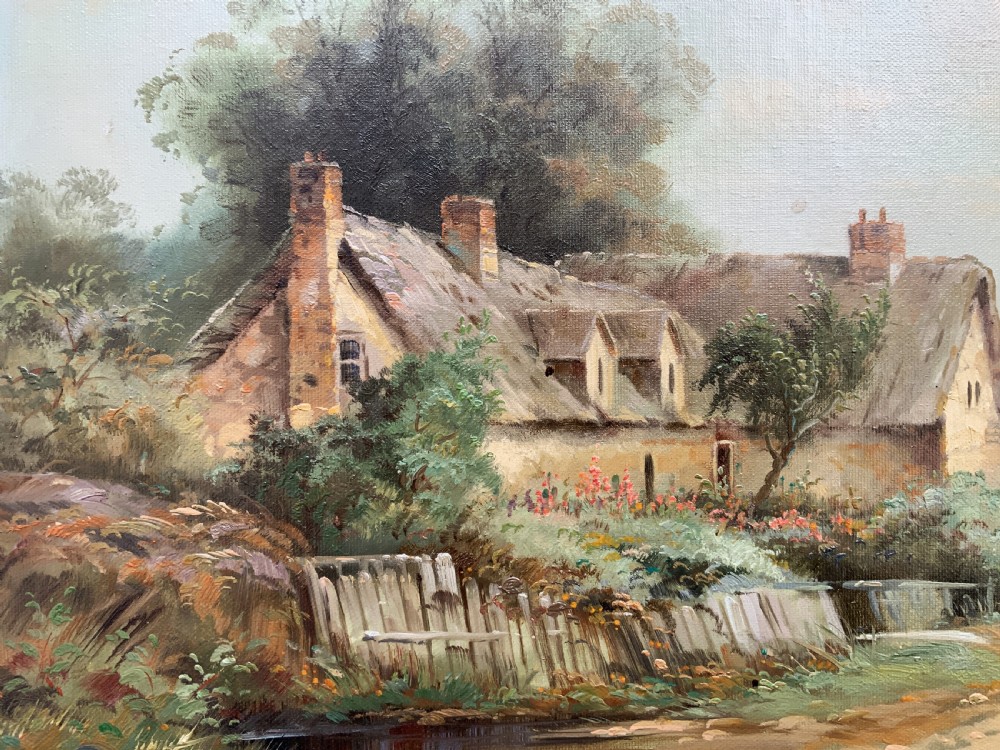 An oil painting depicting a thatched cottage along a dirt lane, housed inside an ornate swept gilt frame with scroll motifs. View IX