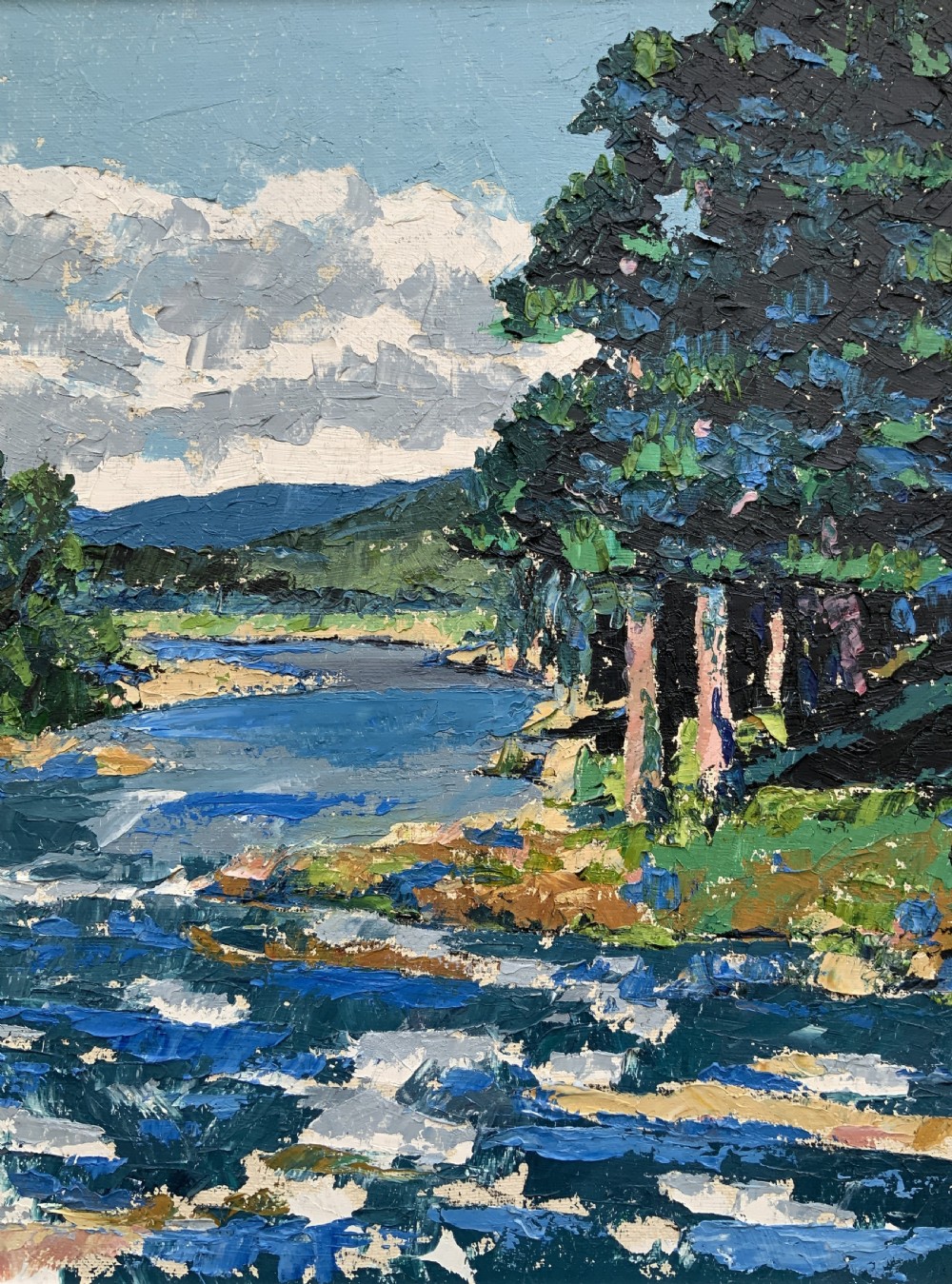 A framed mid-century impressionist oil painting depicting a blue river flowing through a green landscape with trees and hills under a cloudy sky. View V