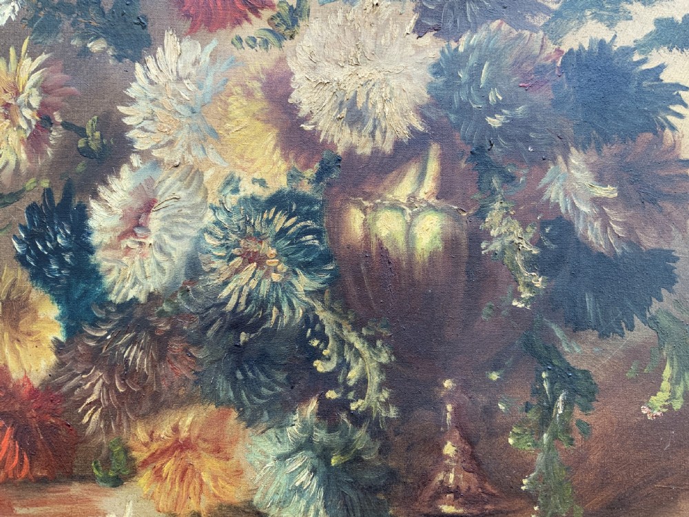 A 19th-century floral oil painting on canvas depicting a dense bouquet of colourful flowers in a vase, enclosed within an ornate, deeply carved gold frame. View VII