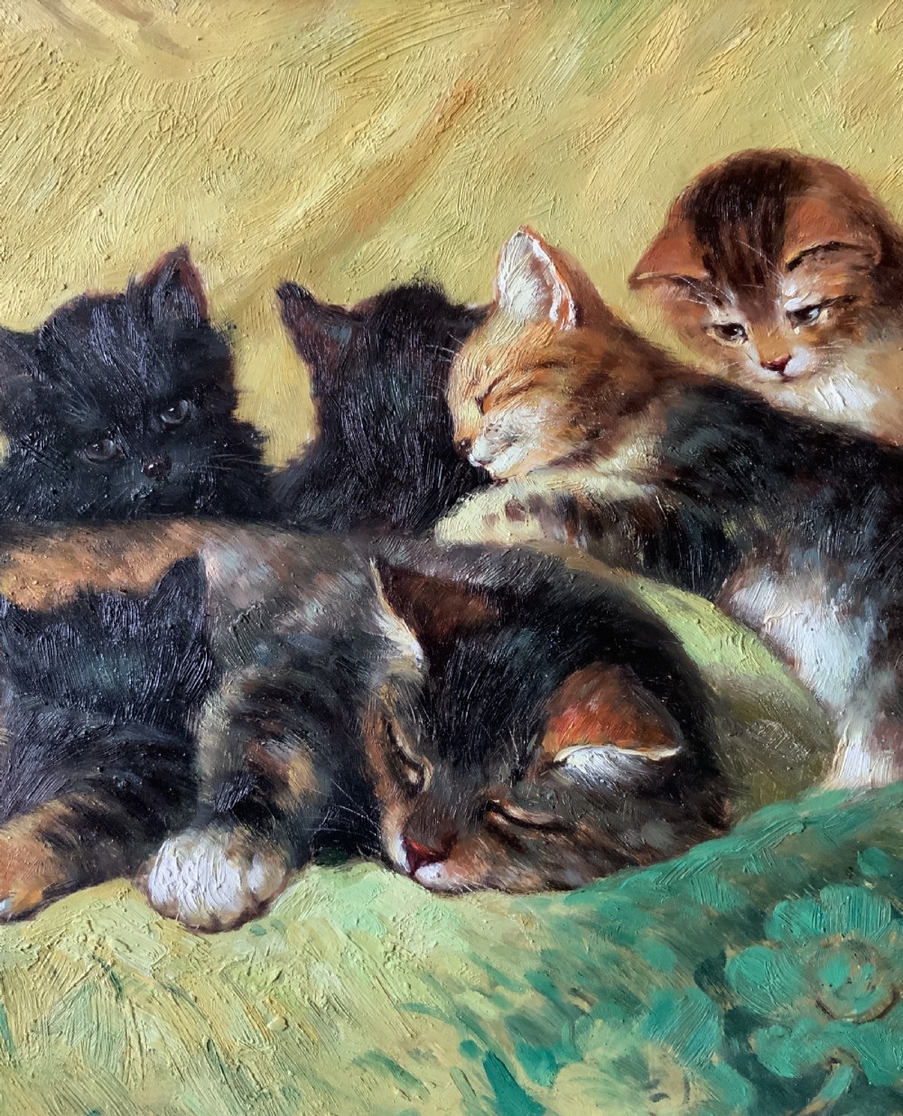 An oil painting on a wooden panel depicting a mother cat and five kittens resting on a green fabric, housed in a wide gilt frame. View IX