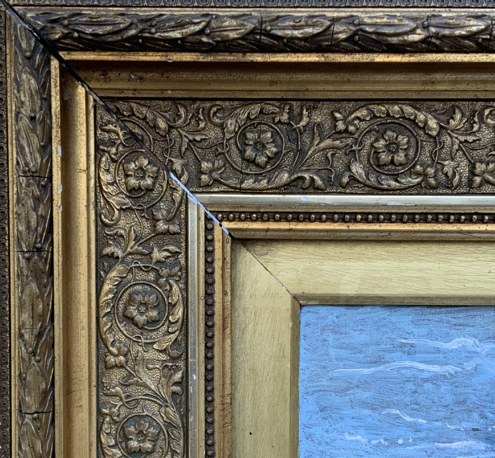 A 19th-century oil painting depicting a young Dutch fisher girl in traditional costume seated near the sea, housed within an ornate gilt wooden frame. View XIV