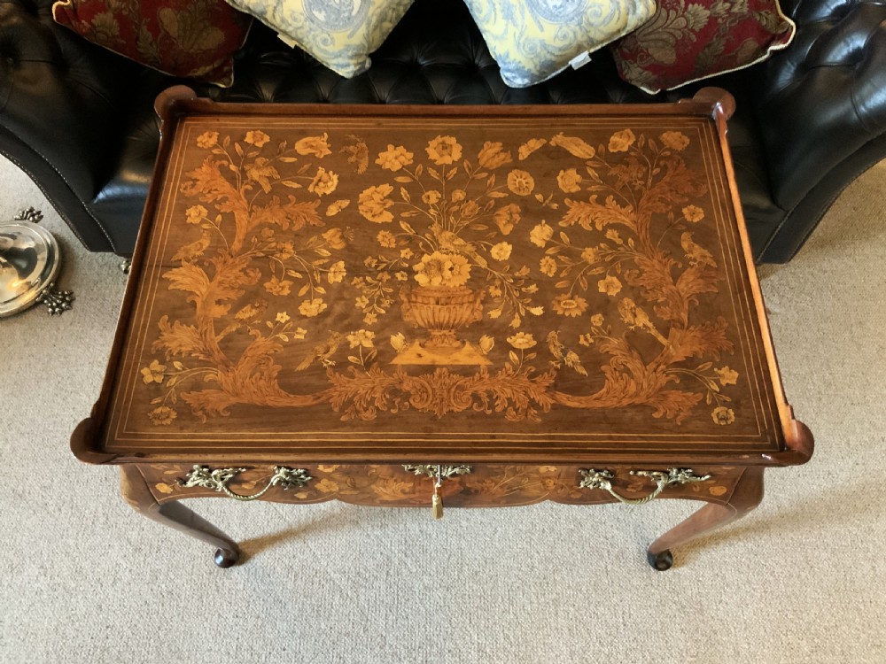 An 18th-century Dutch walnut tea table featuring floral fruitwood marquetry inlays, a tray top, brass handles, and cabriole legs. View III