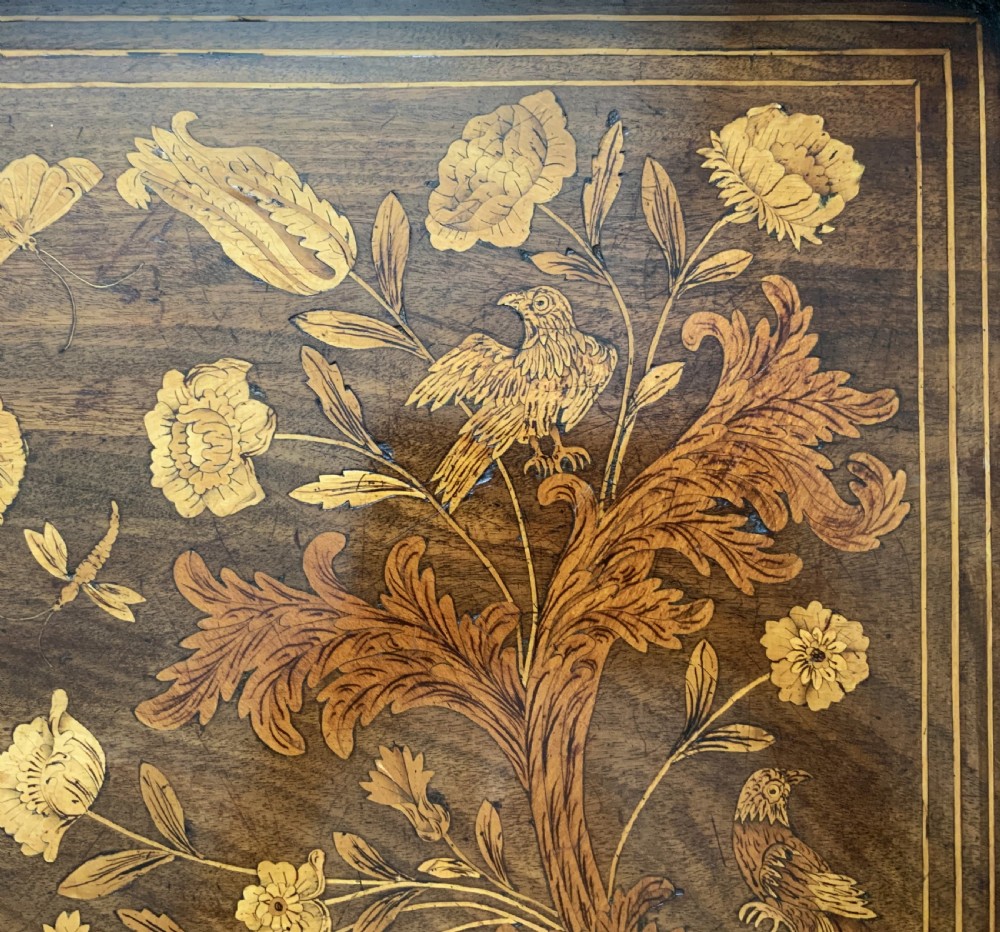 An 18th-century Dutch walnut tea table featuring floral fruitwood marquetry inlays, a tray top, brass handles, and cabriole legs. View X