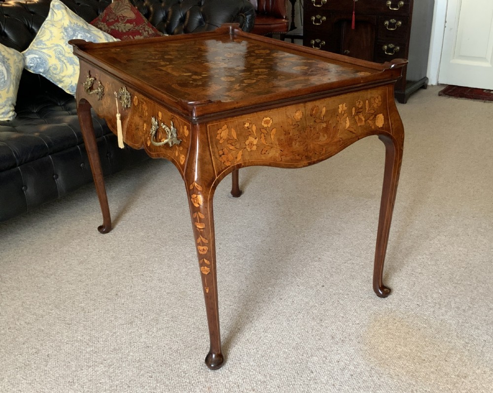 An 18th-century Dutch walnut tea table featuring floral fruitwood marquetry inlays, a tray top, brass handles, and cabriole legs. View XIII