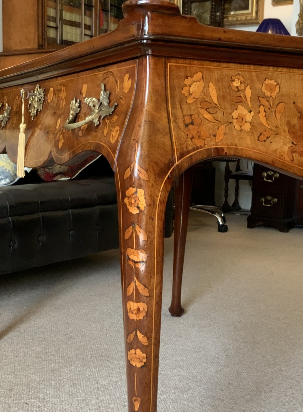An 18th-century Dutch walnut tea table featuring floral fruitwood marquetry inlays, a tray top, brass handles, and cabriole legs. View XIV
