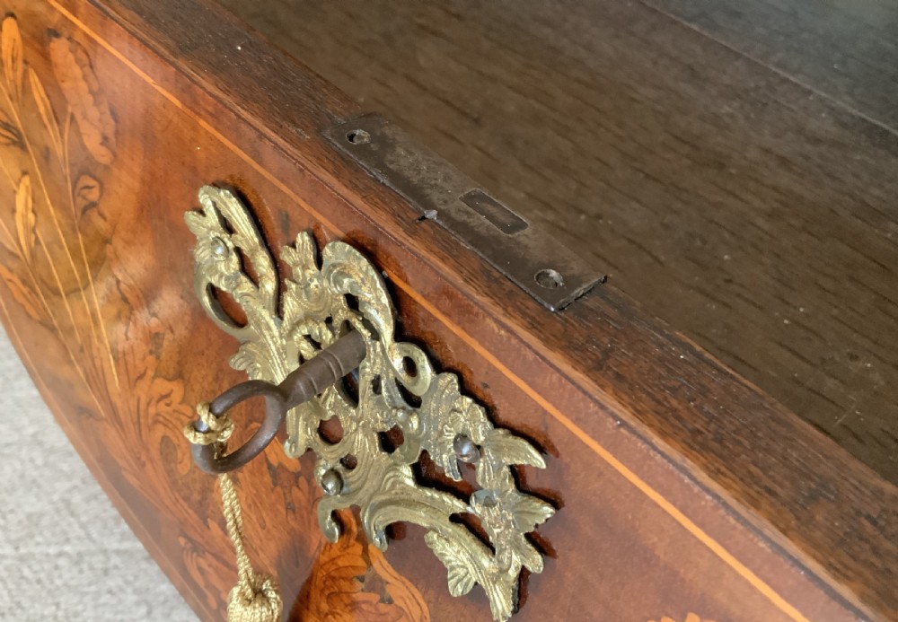 An 18th-century Dutch walnut tea table featuring floral fruitwood marquetry inlays, a tray top, brass handles, and cabriole legs. View XIX