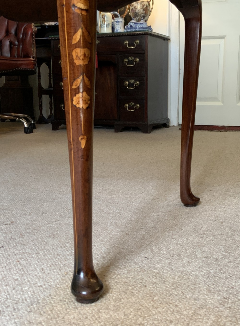 An 18th-century Dutch walnut tea table featuring floral fruitwood marquetry inlays, a tray top, brass handles, and cabriole legs. View XX