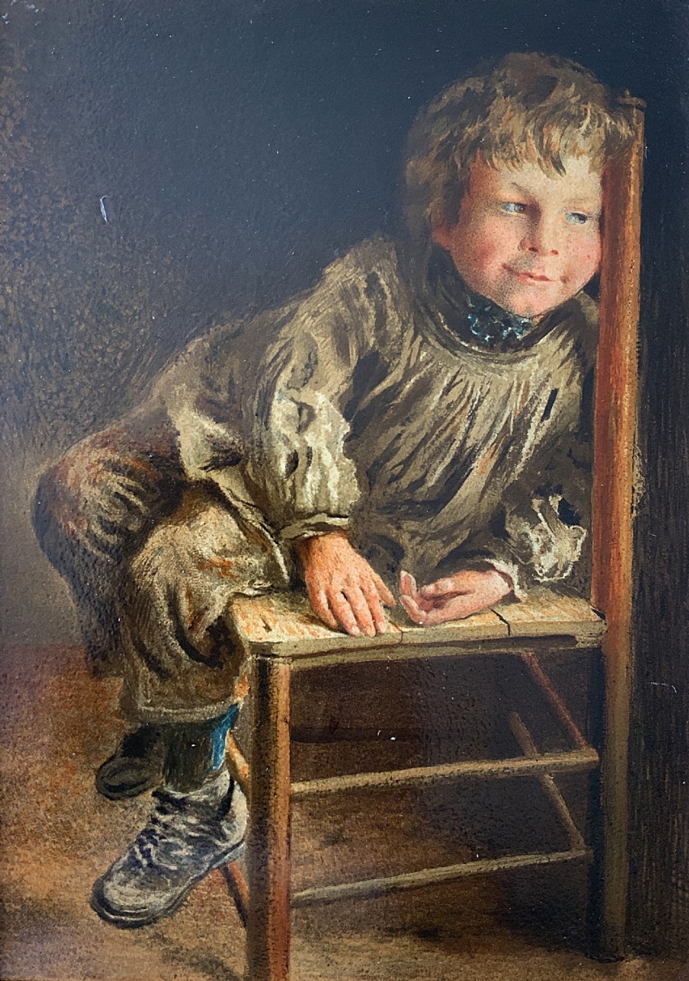 A nineteenth-century Victorian oleograph portrait of a young child sitting on a wooden chair, presented in an ornate gold leaf frame. View II