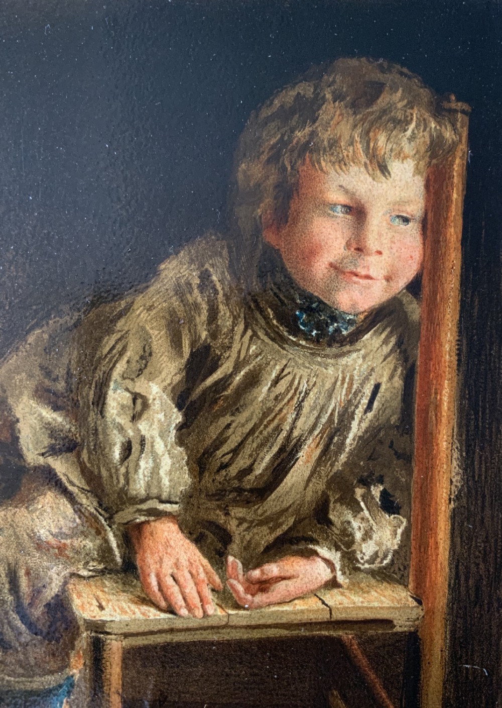 A nineteenth-century Victorian oleograph portrait of a young child sitting on a wooden chair, presented in an ornate gold leaf frame. View VI