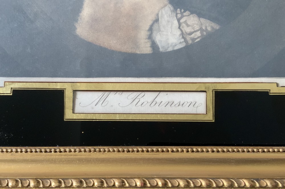 A framed 18th-century hand-coloured portrait engraving of a woman in a bonnet, set within a black glass mount and a beaded gilt frame. View III