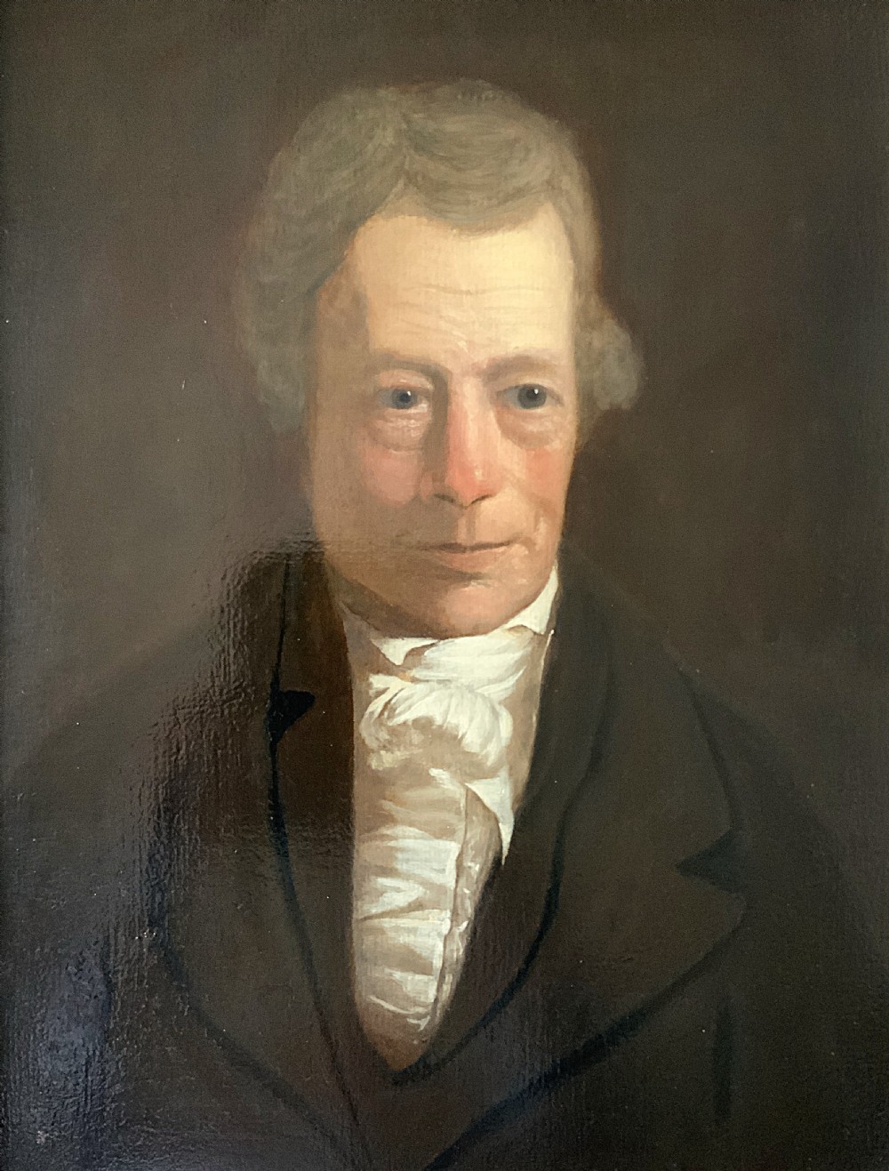 An early nineteenth-century portrait painting of a gentleman wearing a white cravat and dark coat, set within a carved gilt frame. View III