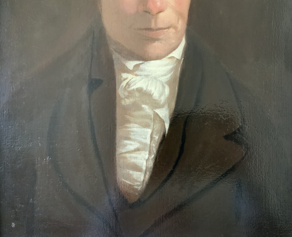 An early nineteenth-century portrait painting of a gentleman wearing a white cravat and dark coat, set within a carved gilt frame. View IV