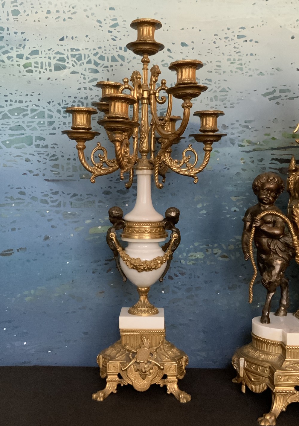 A three-piece antique clock garniture set featuring a central gilt bronze and white marble clock flanked by two matching multi-arm candelabra. View XI