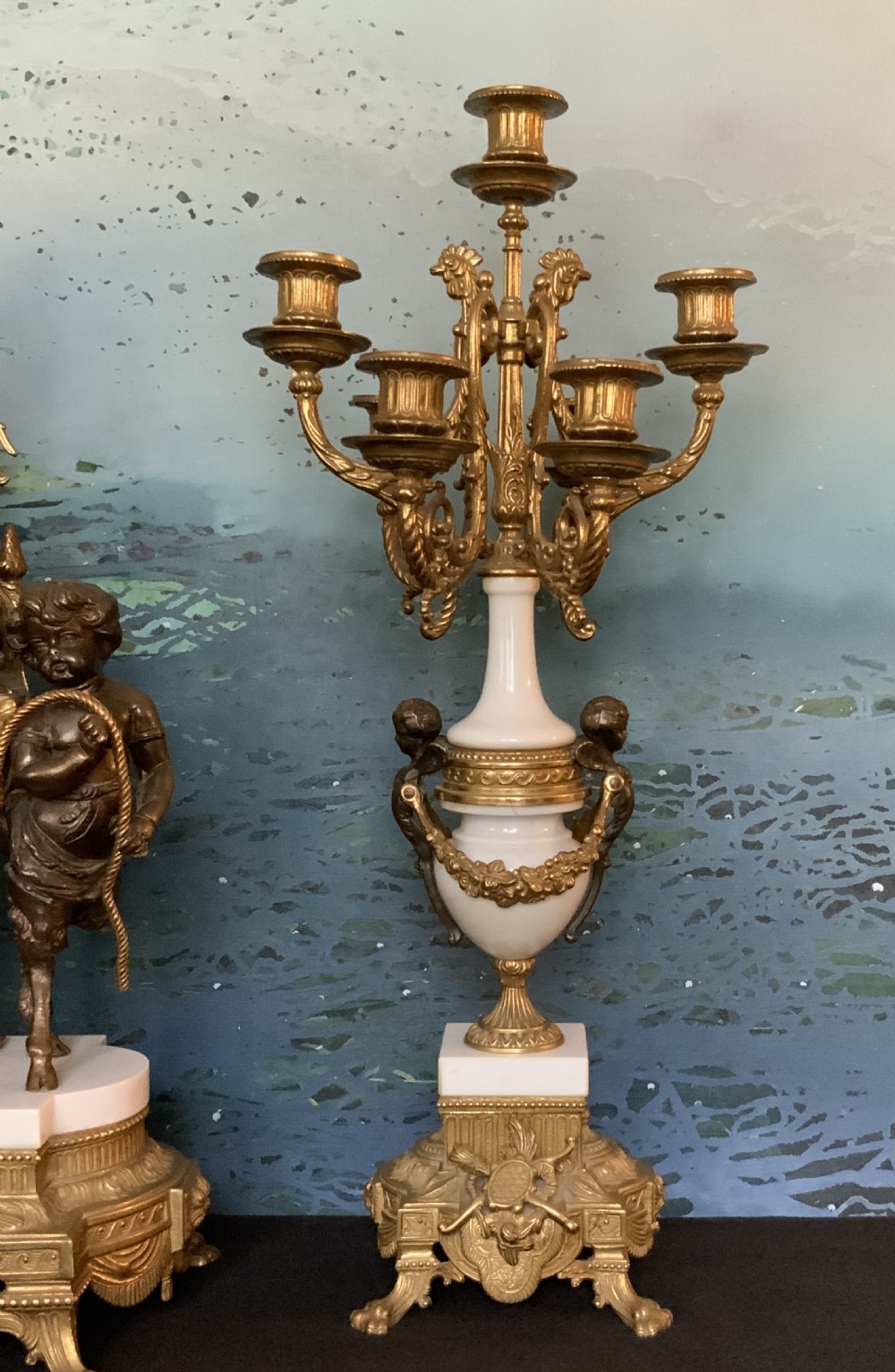 A three-piece antique clock garniture set featuring a central gilt bronze and white marble clock flanked by two matching multi-arm candelabra. View XII