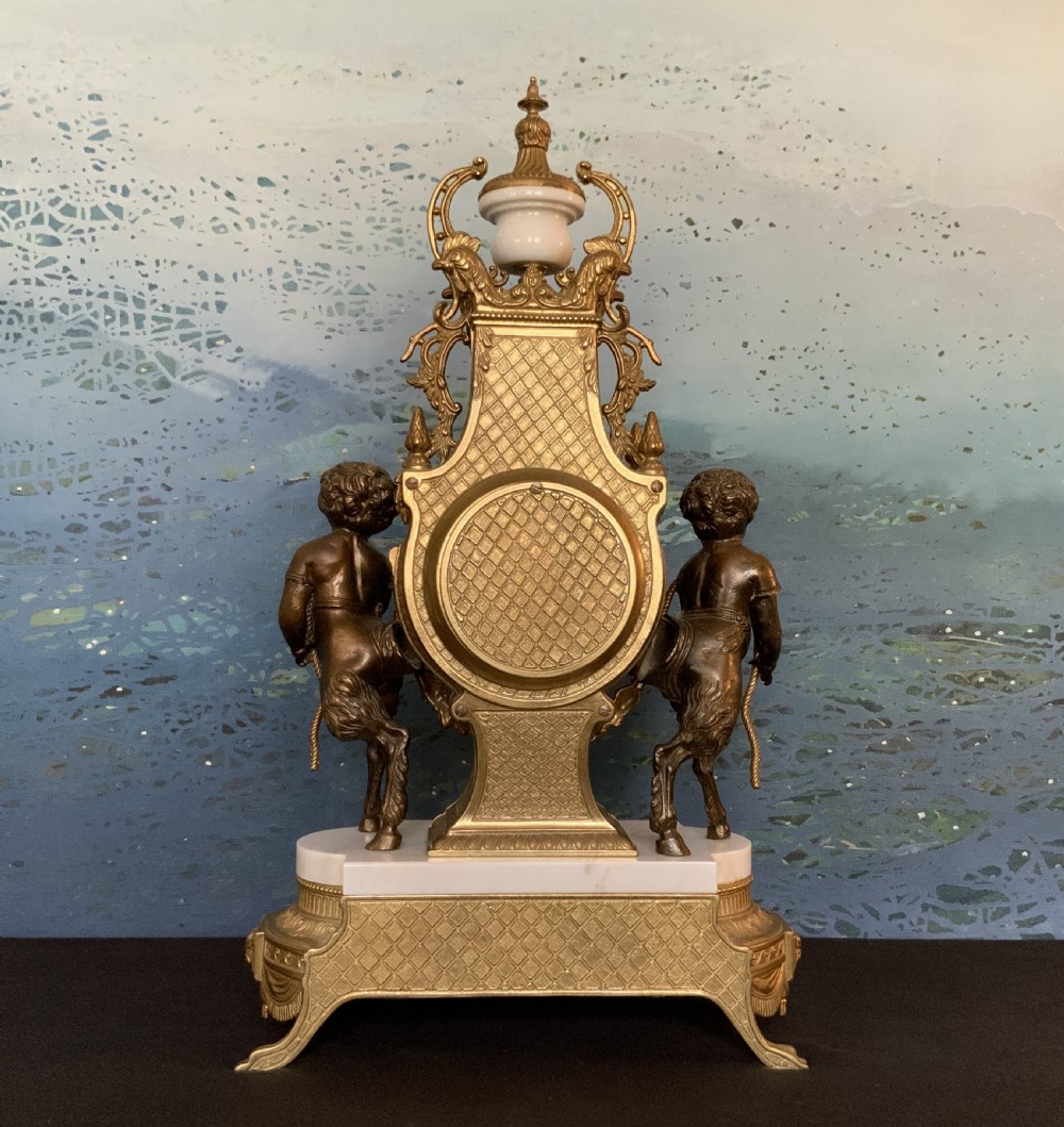 A three-piece antique clock garniture set featuring a central gilt bronze and white marble clock flanked by two matching multi-arm candelabra. View XX