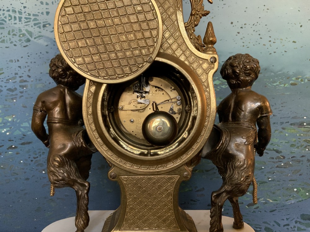 A three-piece antique clock garniture set featuring a central gilt bronze and white marble clock flanked by two matching multi-arm candelabra. View XXI
