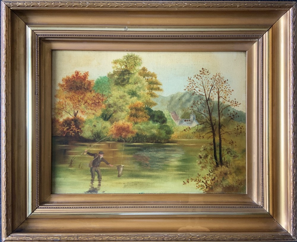 An Edwardian oil painting depicting an angler fly fishing in a river surrounded by trees, enclosed in a moulded gold gilt frame.