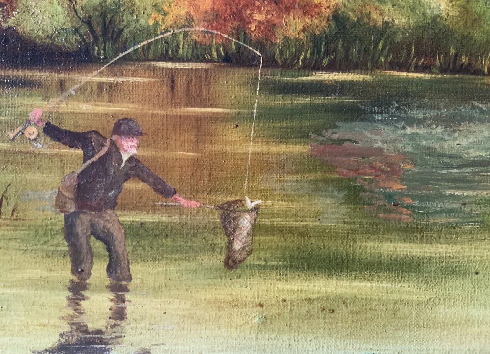 An Edwardian oil painting depicting an angler fly fishing in a river surrounded by trees, enclosed in a moulded gold gilt frame. View IX