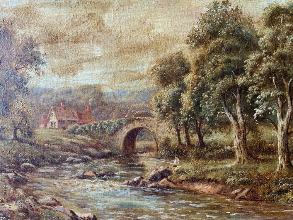 An antique oil painting depicting a tranquil river flowing through a wooded landscape with a stone bridge and cottage in the background, framed in polished dark wood. View V