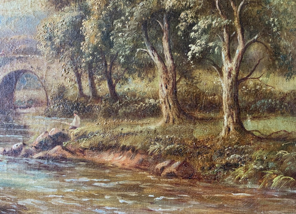 An antique oil painting depicting a tranquil river flowing through a wooded landscape with a stone bridge and cottage in the background, framed in polished dark wood. View XI