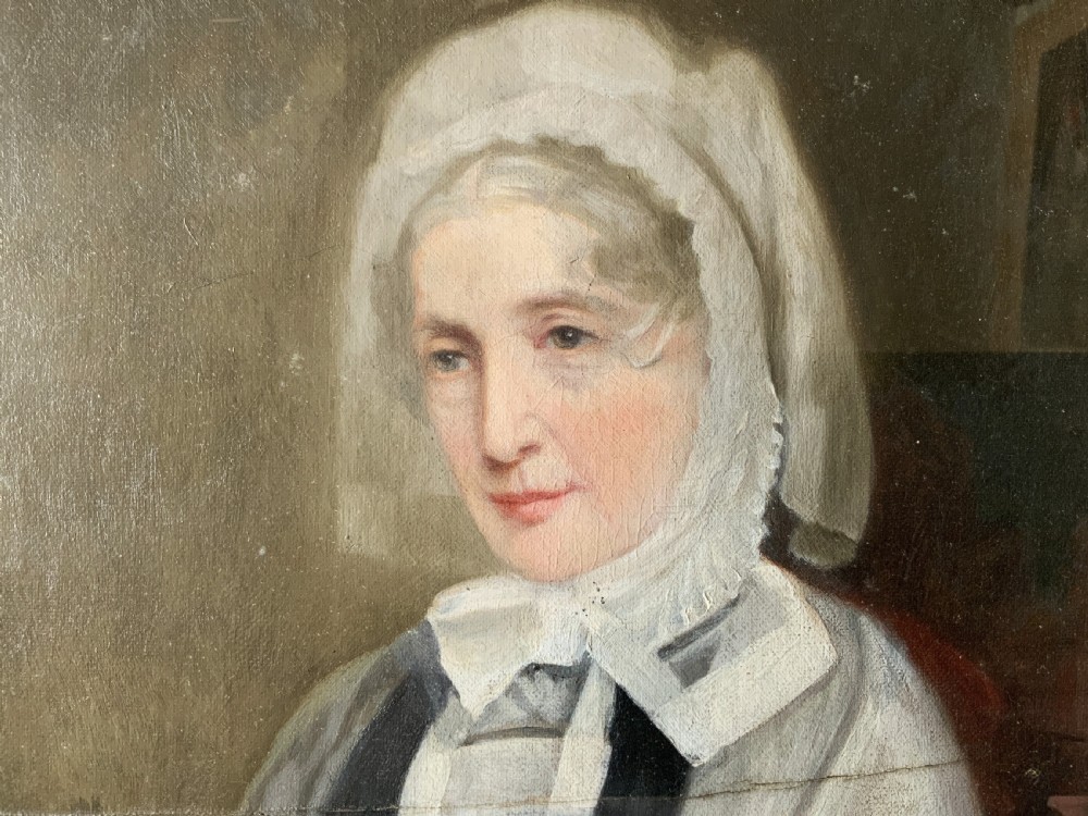 A nineteenth-century oil portrait painting depicting a seated lady wearing a white lace bonnet and grey shawl, housed in a black ebonised frame with a pale inner slip. View VIII